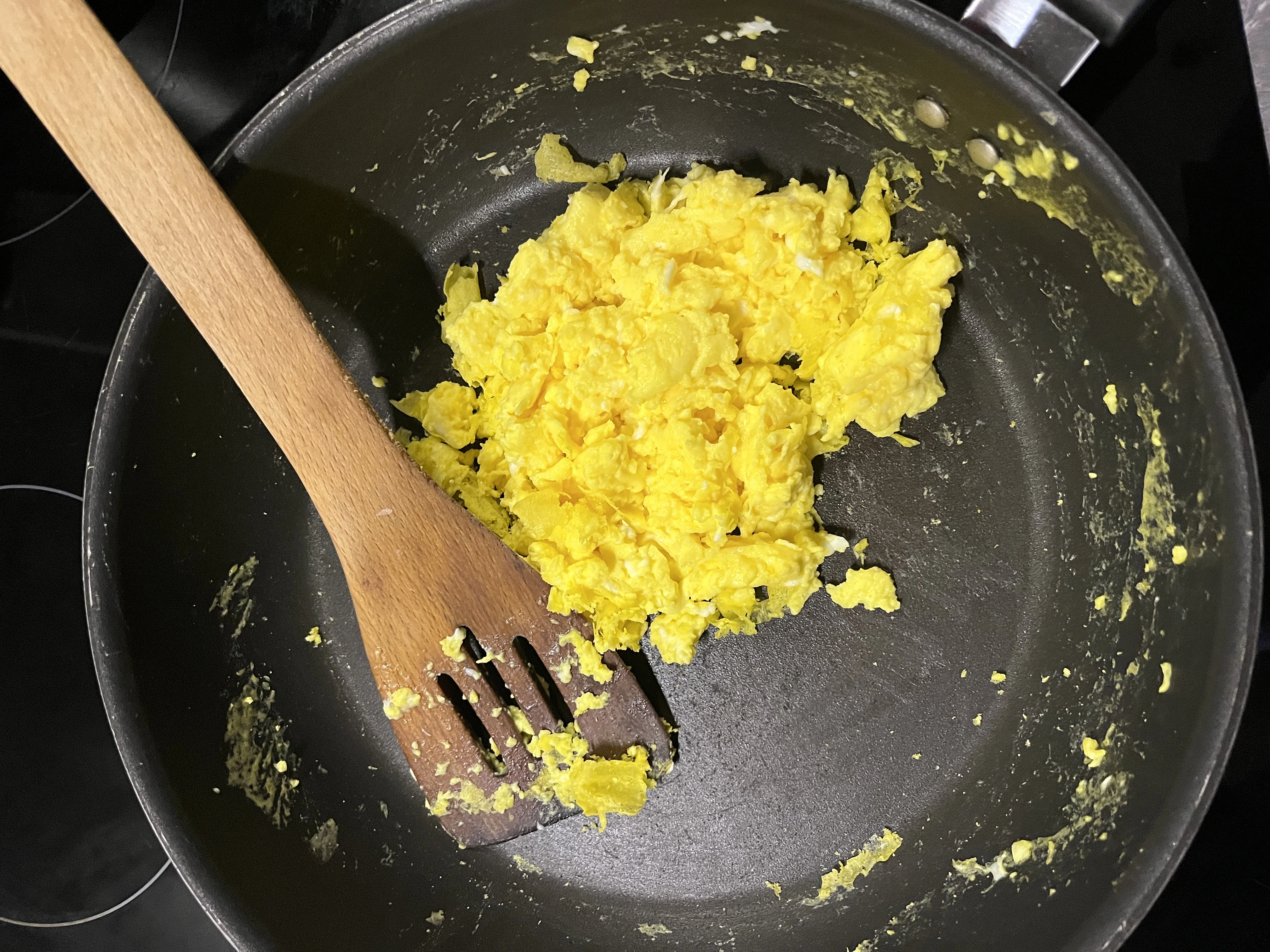 Scrambled eggs mid-cook in a pan