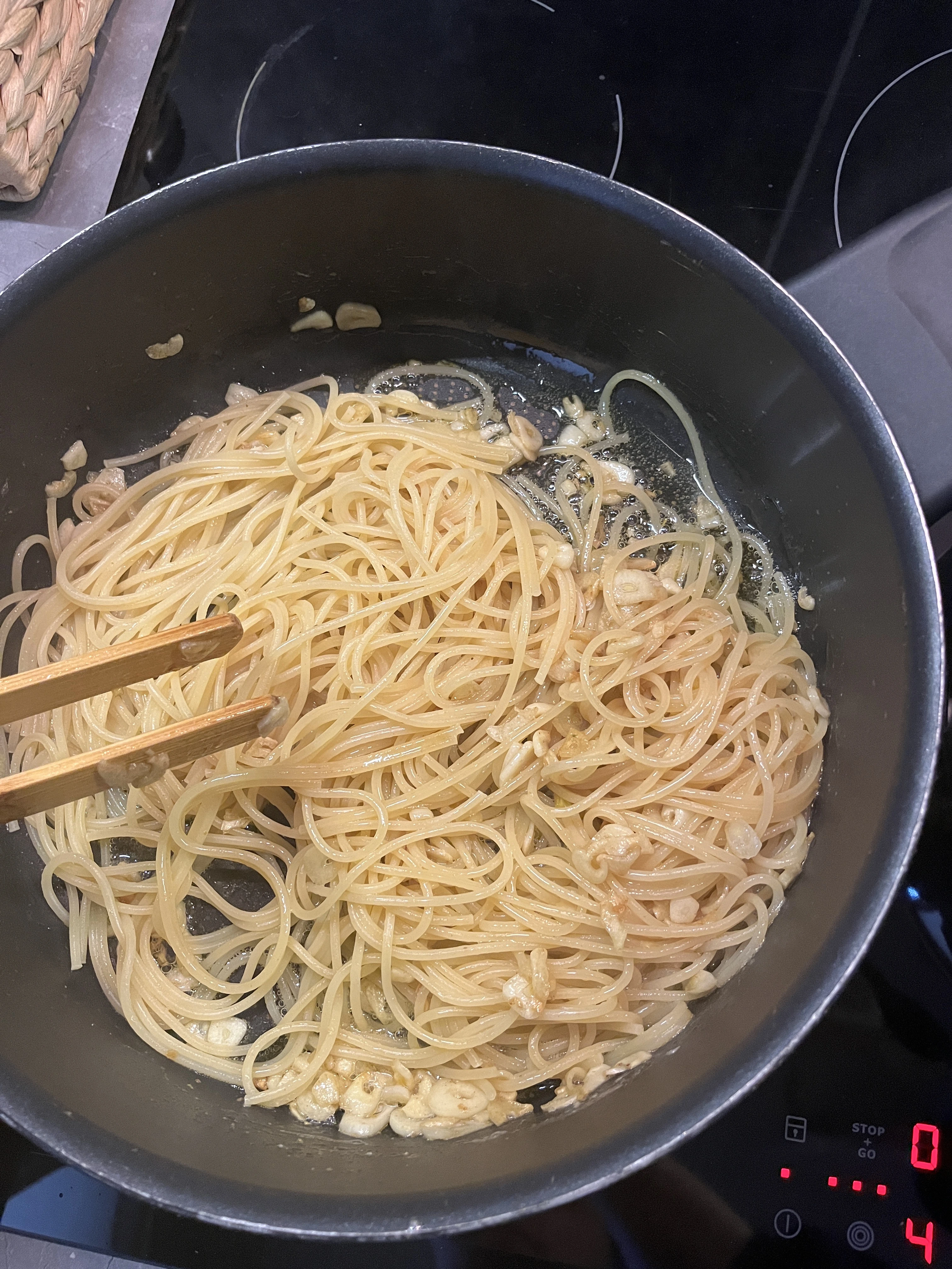 Pasta being stirred with cheese